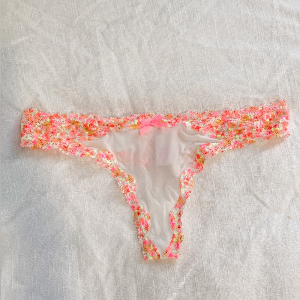 NWT Victoria’s Secret thong. Size: S. Color: white with pink and yellow accents